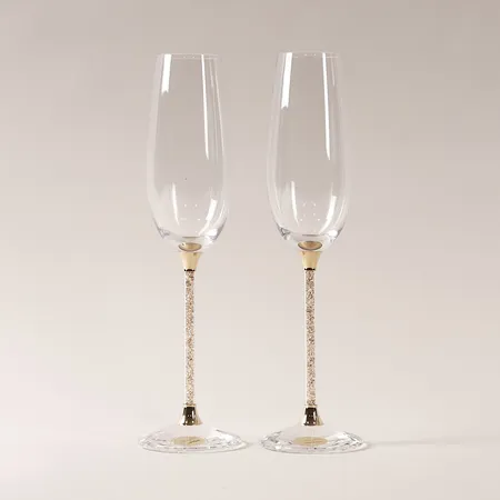 Ett par champagneglas "Crystalline Toasting Flutes" Swarovski, höjd 26cm, originalkartong, obetydligt slitage, kartong med mindre slitage.