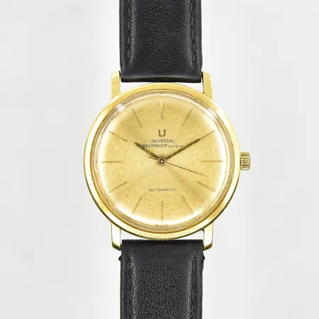 Herrur Universal Genéve Polerouter 18K automat boett Ø34 mm, fläckig urtavla, repig bakboett, fungerade vid testtillfället, slitet läderband.