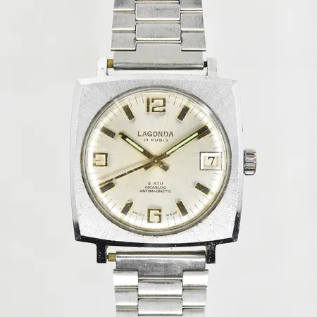 Herrur Lagonda Incabloc Antimagnetic, stål, manuell, datum, boett 34x34 mm, boett nr 70211, defekt länk, defekt datumfunktion, inga tillbehör.