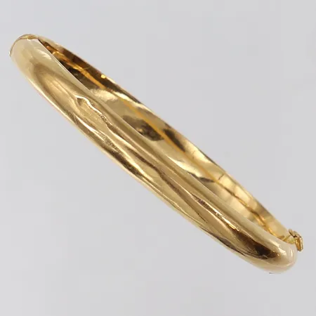 Stelt armband ovalformat ca 58x67mm bredd 6,5mm, något buckligt 18K Vikt: 9,7 g