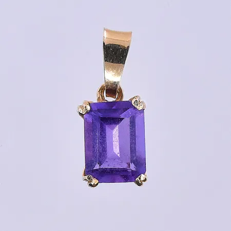 Hänge Guldfynd med lila sten längd 16 mm, bredd 7 mm 18K. Vikt: 0,9 g