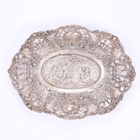 Skålfat med dekor av puti längd 18cm bredd 13cm något bucklig silver 830/1000 Vikt: 124,4 g