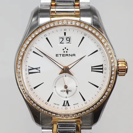 Damur Eterna Kontiki Ø36mm med diamantkrans 68xca0,01ct ref nr. 1270.55 snr. 338.487 med stållänk guld på stål, med box och cert samt manual, visst slitage 