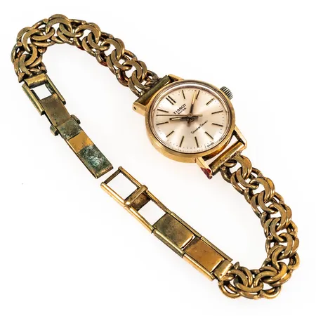 Defekt damur Tissot Seastar Seven i 18K guld med ärgat doubléband. Boett Ø 22 mm med gravyr "För nit...". Manuellt urverk. Repigt plastglas. Går ej. Bucklor.