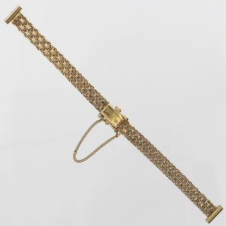 Klockarmband, X-länk med stav, Guldvarufirman Esto AB, Stockholm år 1971, 13,5 cm, bredd: 7 mm, integrerad säkerhetskedja, 18K guld. Vikt: 10,8 g