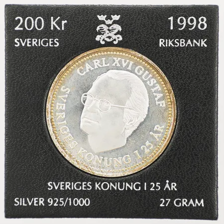 Mynt, Sveriges konung i 25år, nominellt värde 200kr, silver 925/1000, plastetui Vikt: 27 g