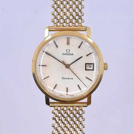 Herrur Omega Genéve Ø34 mm, quartz datum längd 20,5 cm graverad boett 18K.