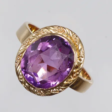 Ring med lila slipad sten stl:18 bredd 3-15mm 18K Vikt: 5,1 g