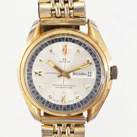 Herrur Sicura Automatic Ø39mm, automatisk, datumfönster, guldfärgat stål, defekt armband, slitage, repor på plexiglas, inga övriga tillbehör