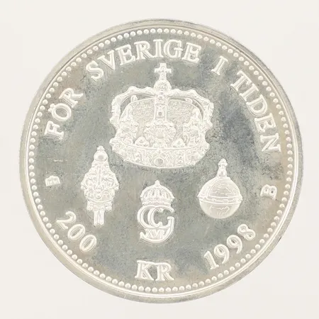 Mynt Sveriges konung i 25år år 1998, nominellt värde 200kr, plastetui, 925/1000 silver  Vikt: 26,9 g