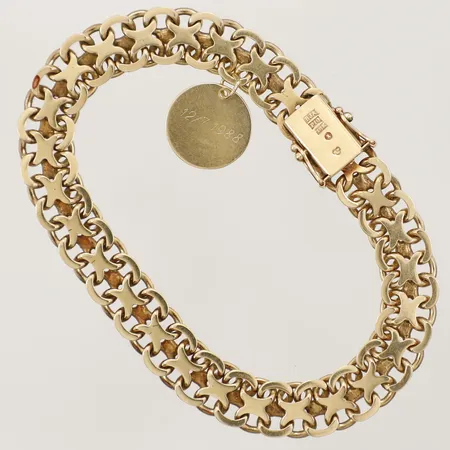 Armband X-länk 21cm, bredd 9,5mm tillverkad av Anderssons Guld Bengt J år 1989 med berlock gravyr 18K Vikt: 29,8 g