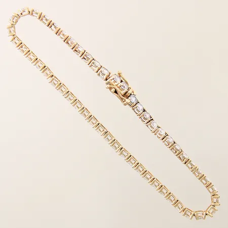Armband med vita stenar längd 19cm bredd 3,3mm, ojämnheter i länk, slappt lås 14K Vikt: 8,6 g