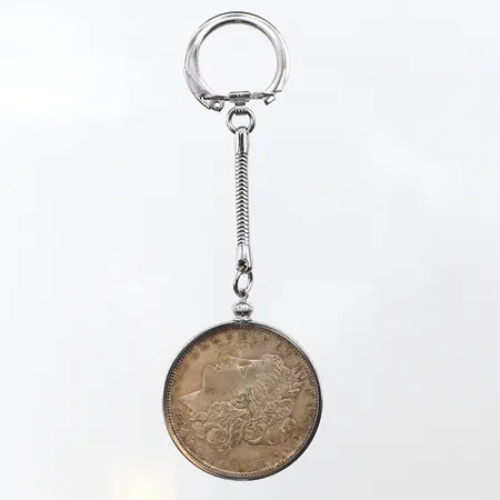 Ett silvermynt, one dollar1884, 900/1000 silver, infattat i stål. Vikt: 34,7 g