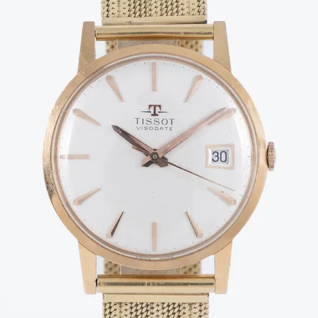 Herrur Tissot Visodate i 18K guld med band i 18K. Boett Ø 34 mm, manuell, datum, plexiglas. OBS! Kort band, justerbart i längd 16,5/17/17,5 cm. Bruttovikt: 58,2g.
