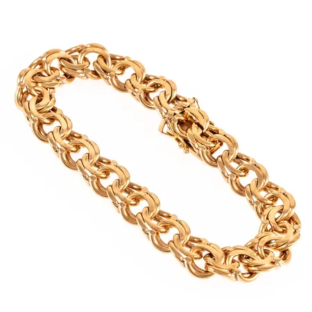 Armband Bismarck i 18K guld. Det är 19 cm långt, 10,5 mm brett och väger 38,4g. Kistlås. Stämplad N9 (1963), BRG (Bernt Gottschalk Guld, Skärholmen), 18K, kattfot.  