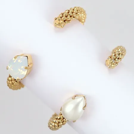 Två armband Caroline Svedbom "Classic rope" Ø55mm, gulmetall, pärlimitation samt glassten, ett etui.