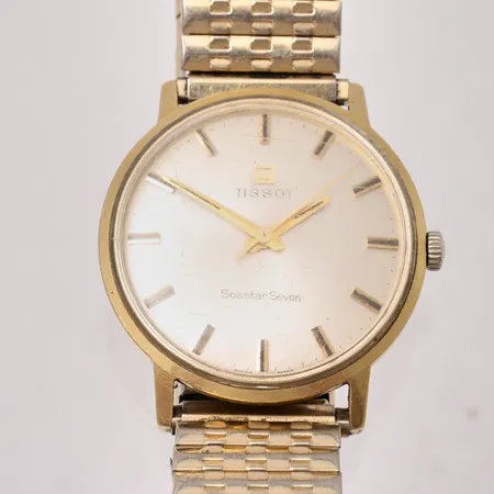 Herrur Tissot Seastar seven i 18K, manuell, Ø34mm, flexband i metall, repor på glas, inga tillbehör.