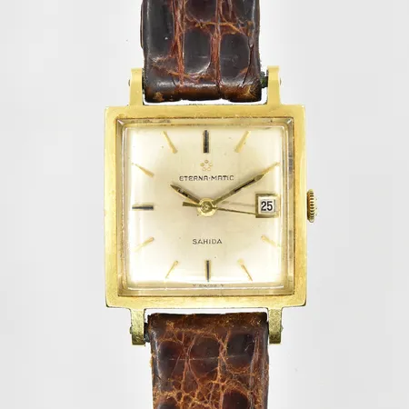 Damur Eterna Matic Sahida 18K, automat, boett 23x23mm, boettnr 6039301, datum, slitet läderband, bruttovikt 23,9g.