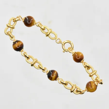 Armband med tigeröga längd 17½cm, länkens bredd 6mm, 18K. Vikt: 9,2 g