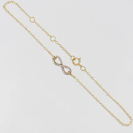 Armband justerbar längd 17-19cm bredd 0,5-4,5mm, integrerat hänge evighetstecken med diamanter ca 25x0,005ct 18K Vikt: 1,1 g