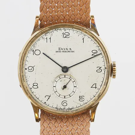 Herrur Doxa 18K manuell, 35mm, boettnr 785968, löst plexiglas, tygband med slitage, inga tillbehör