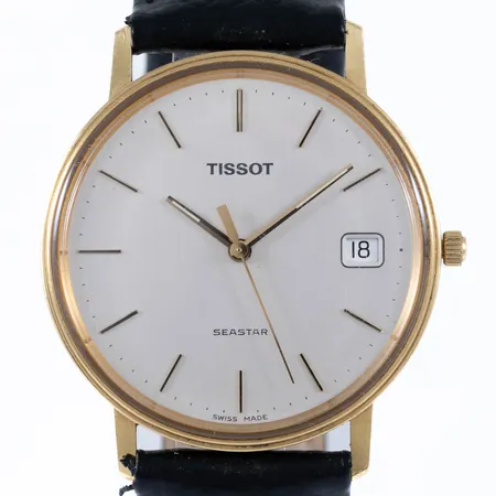 Herrur Tissot Seastar guld 18K quartz 33,5mm datum, plexiglas, svart läderband (nytt) silverfärgat spänne, repigt glas, namn- och företagsgravyr. Går ej, batteribyte krävs?
