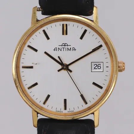 Herrur Antima 18K, quartz, 33mm, boettnr 20556.4100.68, datum, går ej, gravyr, repig, slitet läderarmband, inga tillbehör. 