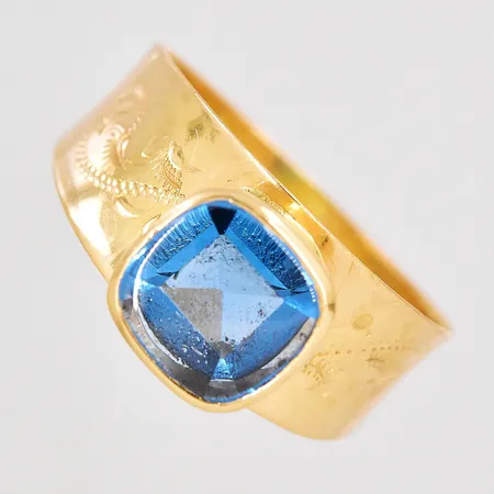 Ring med blå sten stl:17½, bredd 3-8mm, skev skena, 18K. Vikt: 2,6 g