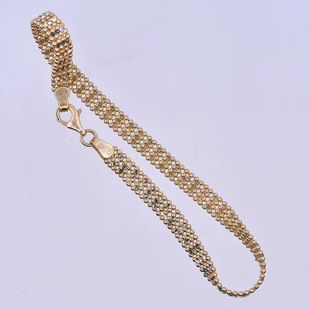 Armband längd 18,5 cm, bredd 5 mm vriden och defekt länk 18K. Vikt: 5,7 g