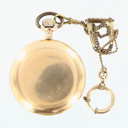 Fickur 18K, innerboett i metall, Fabrique Movado urtavla Ø40mm, boett Ø52mm, liten sekundvisare, klockkedja i förgylld metall, sprickor i urtavlan. Bruttovikt: 97,8gram.