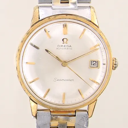Herrur Omega Seamaster guld/stål automat boett-nr:166.002 serie-nr:22270889 Ø34mm kaliber:562, datum, plexiglas samt boett med mindre repor, stållänk ej original samt defekt, packning saknas, lätt slitage i urverk, angripna visare, lysmassa saknas, krona med färgbortfall, inga tillbehör