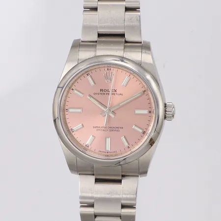 Damur Rolex Oyster Perpetual, stål, automatisk, Ø34mm,  ref-nr 124200, serie-nr R74X1760, cal 2232, verk-nr 060R93T7, boett-nr 2470, rosa tavla, certifikat November 2020, kvittokopia Nymans Ur, 9 länkbitar monterade, tre extra länkbitar, bruksskick, nagg på safirglas, repor, tag, manual, box, ytterkartong