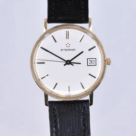 Herrur Eterna quartz datum Ø34 mm, graverad boett 14K.