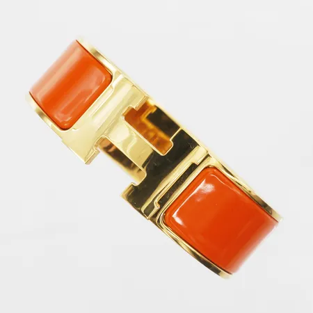 Armband Hermès, Clic Clac H, gulmetall med orange emalj, ref-nr: H300001F, serie-nr: ST0159, bredd 19,5mm, reseetui, ytterkartong, kvitto.