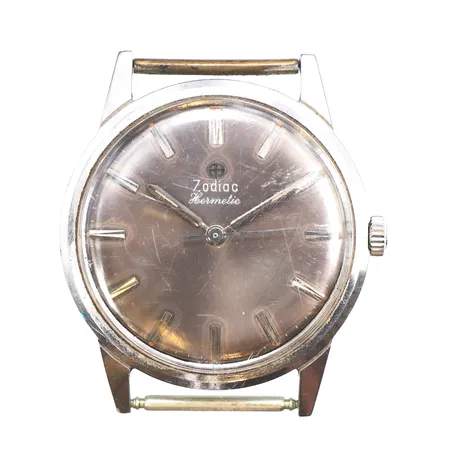 Herrur Zodiac Ø33mm, Hermetic, manuell, stål, numrerad, repigt glas, inga tillbehör.