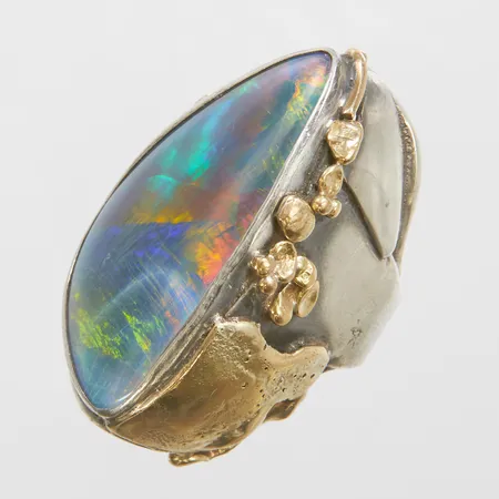 Ring med en boulder opaltriplett, stl:16½, bredd: 7,6-39,5mm, detaljer i 18K, sprickor i opalen, silver 800/1000, bruttovikt 26,0g Vikt: 26 g