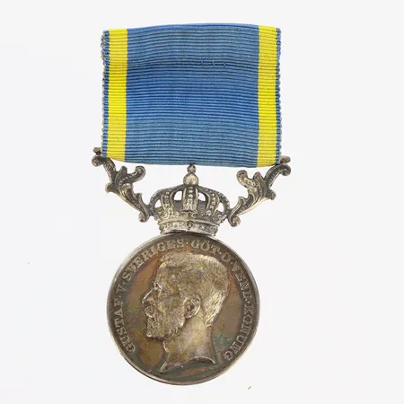 Kunglig medalj, "För nit och redlighet i rikets tjänst", med gult och blått ripsband, personlig gravyr, höjd 4,5cm, etui, 830/1000 silver, bruttovikt 18,9g Vikt: 0 g