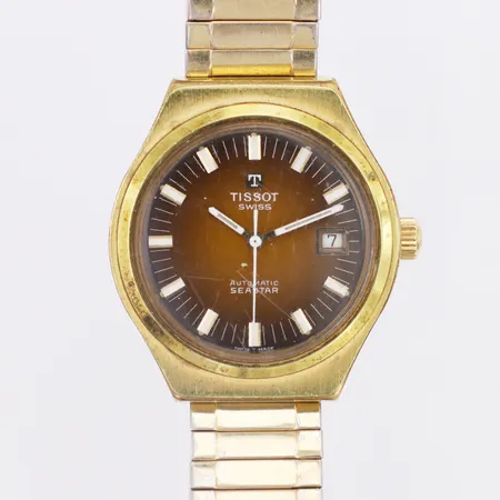 Herrur Tissot Seastar automatisk stål Ø ca 37mm, plastglas, datum, flexlänk i metall graverad bakboett