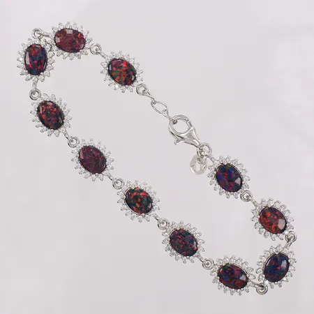 Armband med syntetiska opaler och stenar ca längd 18,5-20cm, bredd 10mm. 925/1000 silver Vikt: 12,7 g