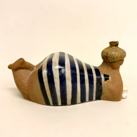 Figurin Beata Lisa Larson för Gustavsberg, ur serien ABC-flickorna, höjd ca 9cm, längd ca 19cm,  signerad L.L, bemålat och glaserad stengods, åldersrelaterat slitage, färgsläpp vid näsan Skickas med postpaket.