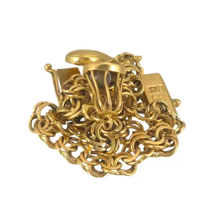 Armband Bismarck med två berlocker i 18K guld, tillverkarstämpel AM, svensk kontrollstämpel, längd knäppt 19,5 cm, bredd 5 mm, en berlock defekt Vikt: 9,9 g