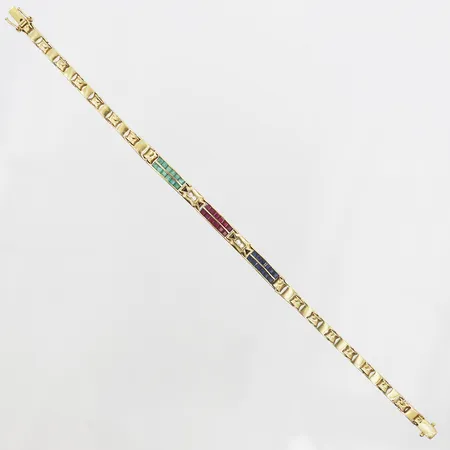 Armband med rubiner safirer smaragder samt diamanter 4 x ca 0,02ct, längd 18,5cm, bredd 5mm, 18K.  Vikt: 14,3 g