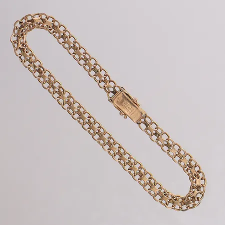 Armband X-länk, längd 19cm bredd 5,3mm, glapp i ena låsåttan. 18K Vikt: 7,9 g