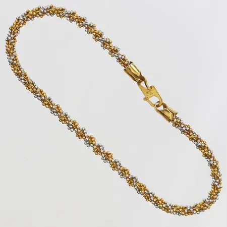 Armband tvinnad modell längd 19cm, bredd 3mm, gul/vitguld, något buckligt lås, 22K. Vikt: 7,8 g