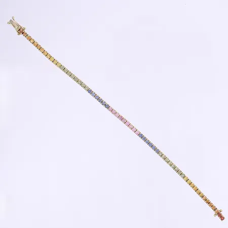 Tennisarmband med färgade safirer totalt 58xca 0,03ct 17cm bredd 3mm tillv. Hedens Guld Watches and Jewelry AB, bruten i ledningen vid kistlås, något trögt lås, 18K Vikt: 11,8 g