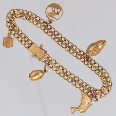 Armband x-länk längd 19cm, bredd 7mm, fem berlocker, 18K Vikt: 15 g