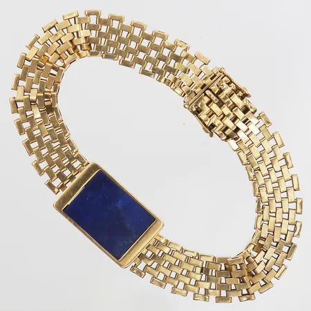Armband korridorlänk med platta i lapis lazuli, mått 16 x 12mm, längd på armband 18½cm, bredd 10-14mm, kistlås med dubbla låsåttor, 18K guld Vikt: 20,5 g