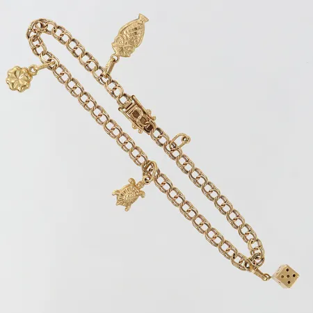 Armband med fyra berlocker längd 17,5cm bredd 3,5mm en berlock sakans 18K. Vikt: 5,7 g