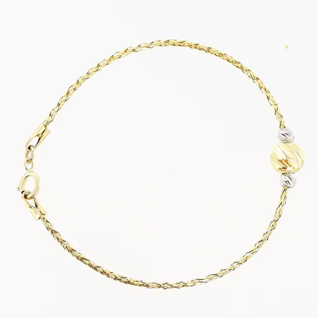 Barnarmband halvstelt längd 13,5cm, bredd 3-5mm, detaljer i vitguld 18K Vikt: 1,1 g