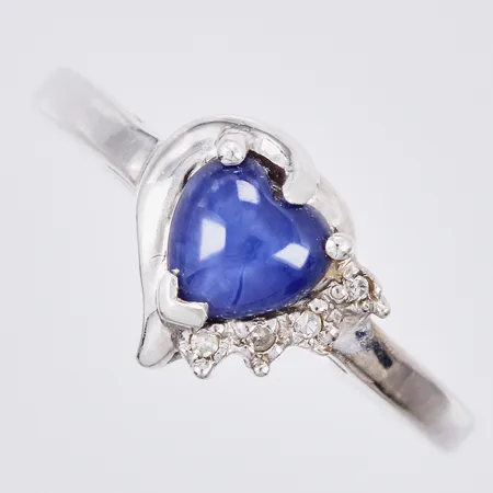 Ring med blå stjärnsafir och diamanter ca 4x0,001ct åttkantslipade stl. ca 18 bredd: ca 1,5-10mm vitguld 10K  Vikt: 2,5 g